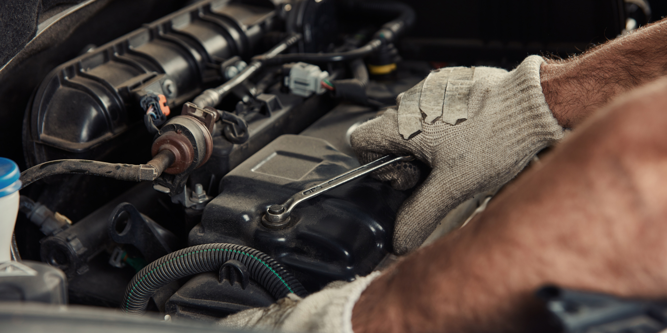 Hand on Engine at Car Repair in Workshop